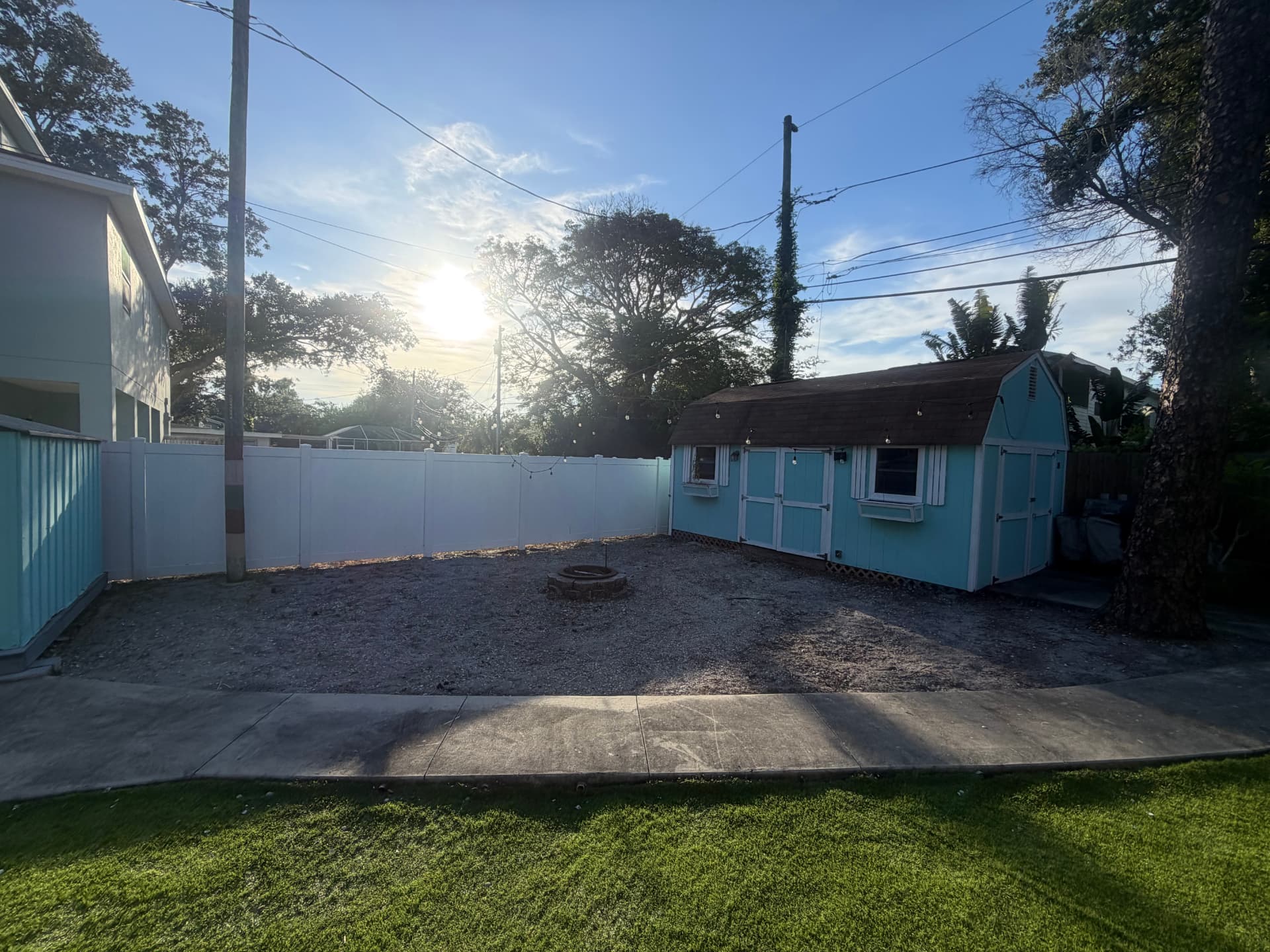 Same backyard after cleanup, cleared and raked